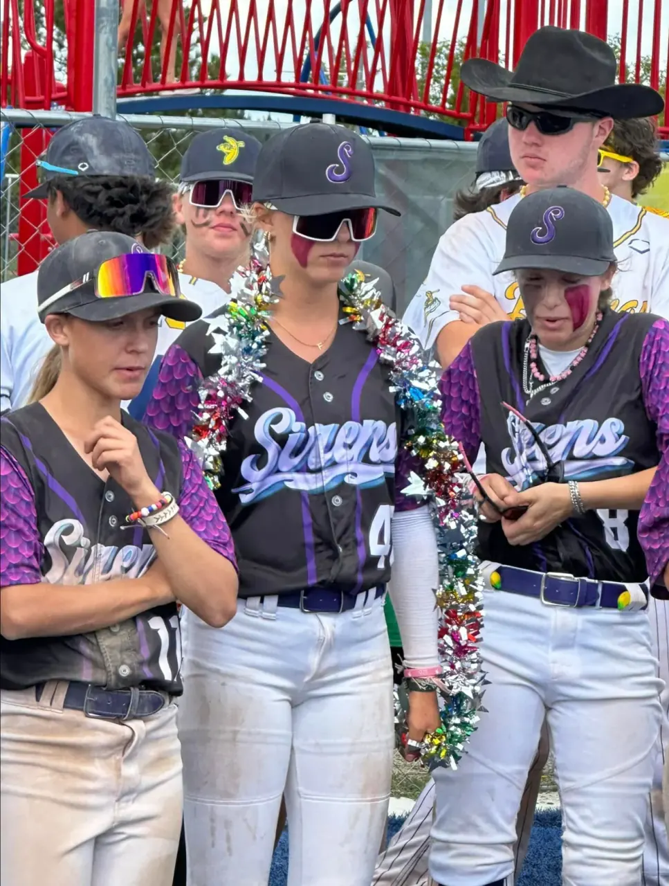 Finleigh Kane in a Savannah Bananas Sirens jersey with teammates