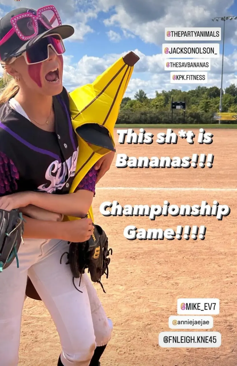 Finleigh Kane on the field holding a banana costume before a championship game