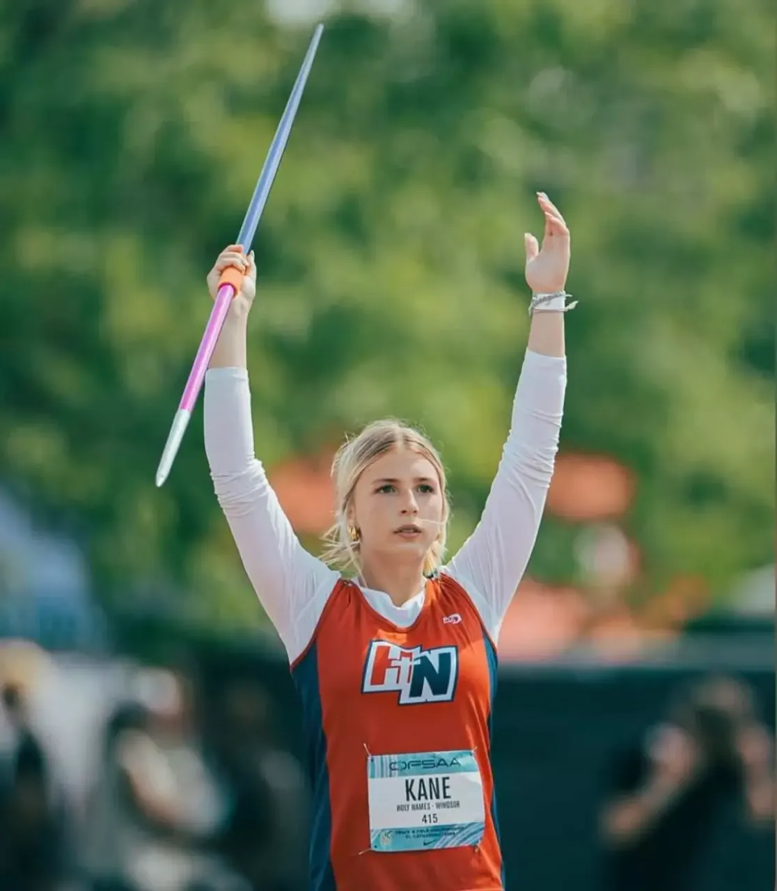Finleigh Kane in the javelin circle for Holy Names, arm raised before the throw