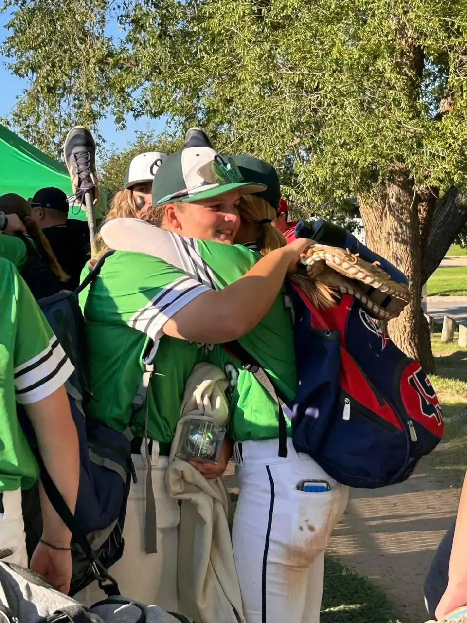 A Team Ontario teammate hugging Finleigh Kane after a game
