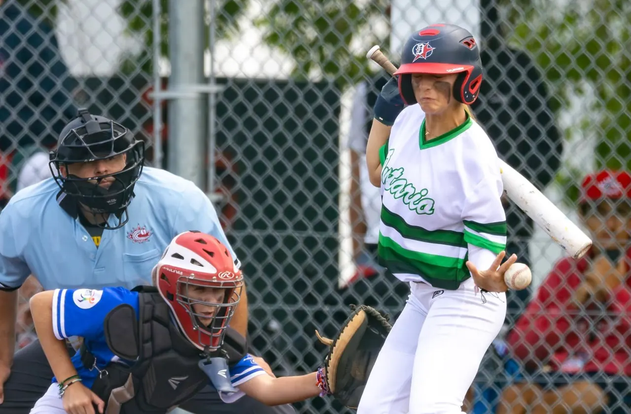 Finleigh Kane batting for Team Ontario as the catcher reaches for the pitch