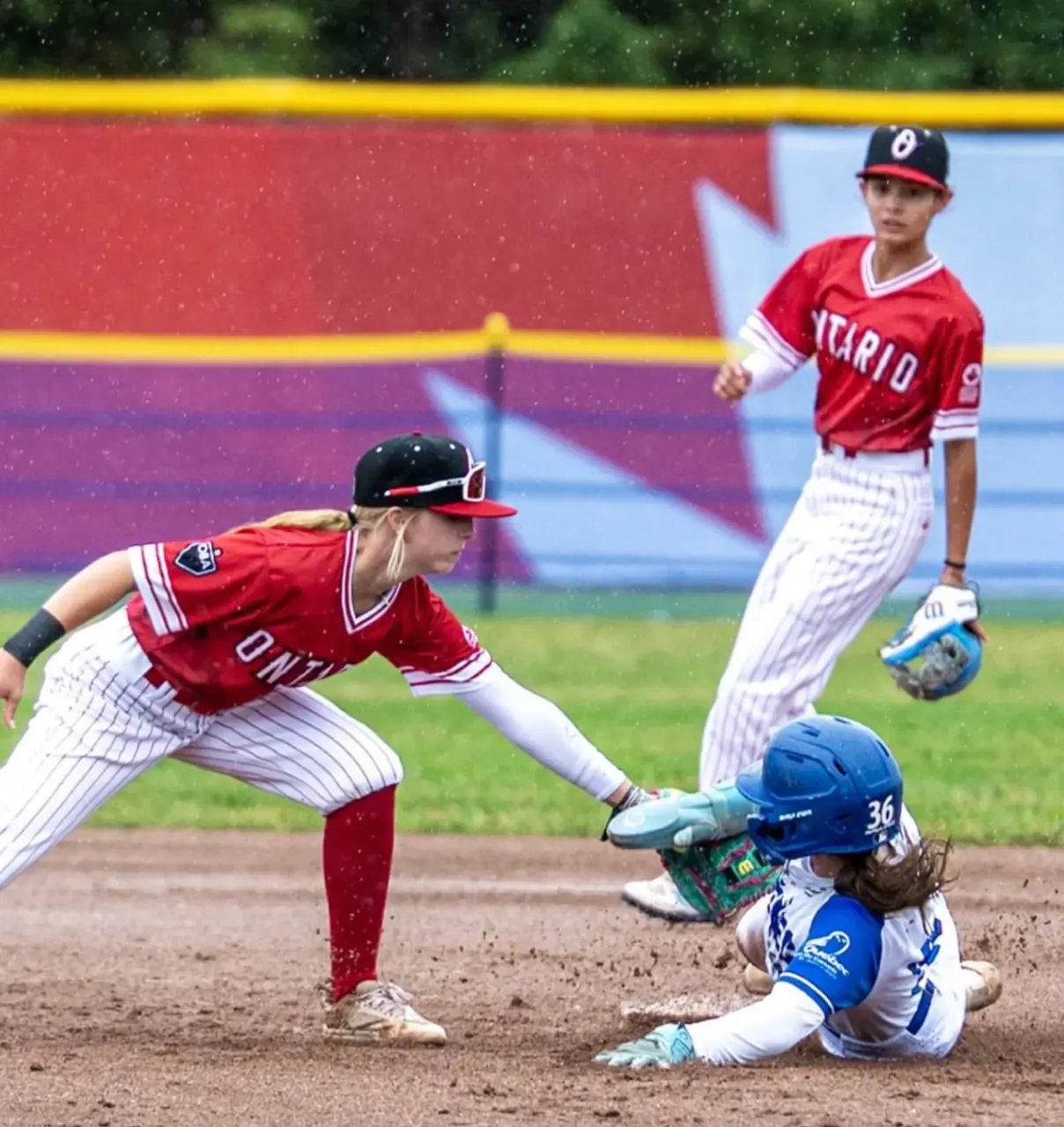 Finleigh Kane covering the bag for Team Ontario as a runner slides in