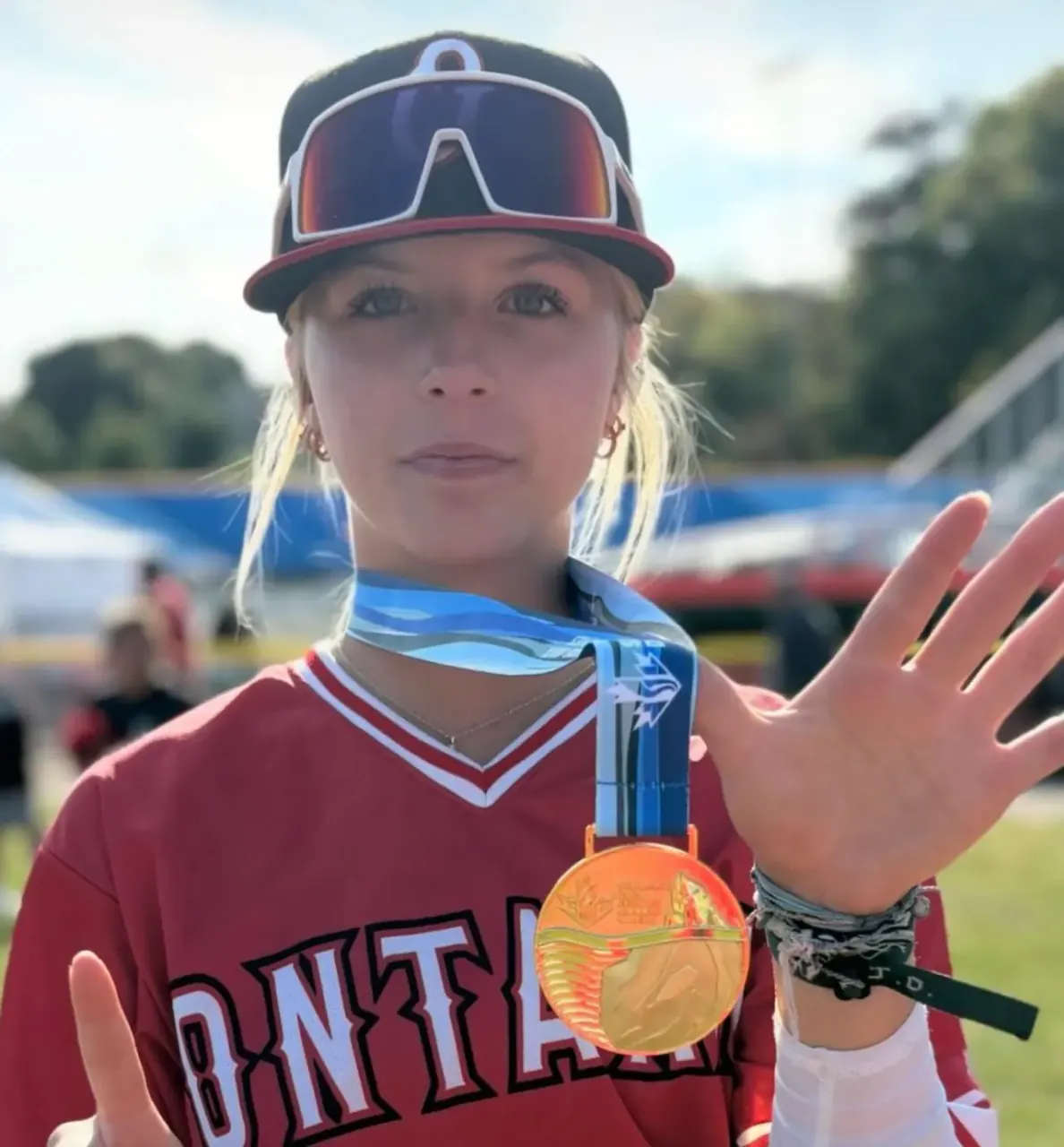 Finleigh Kane in a Team Ontario jersey holding up a gold medal