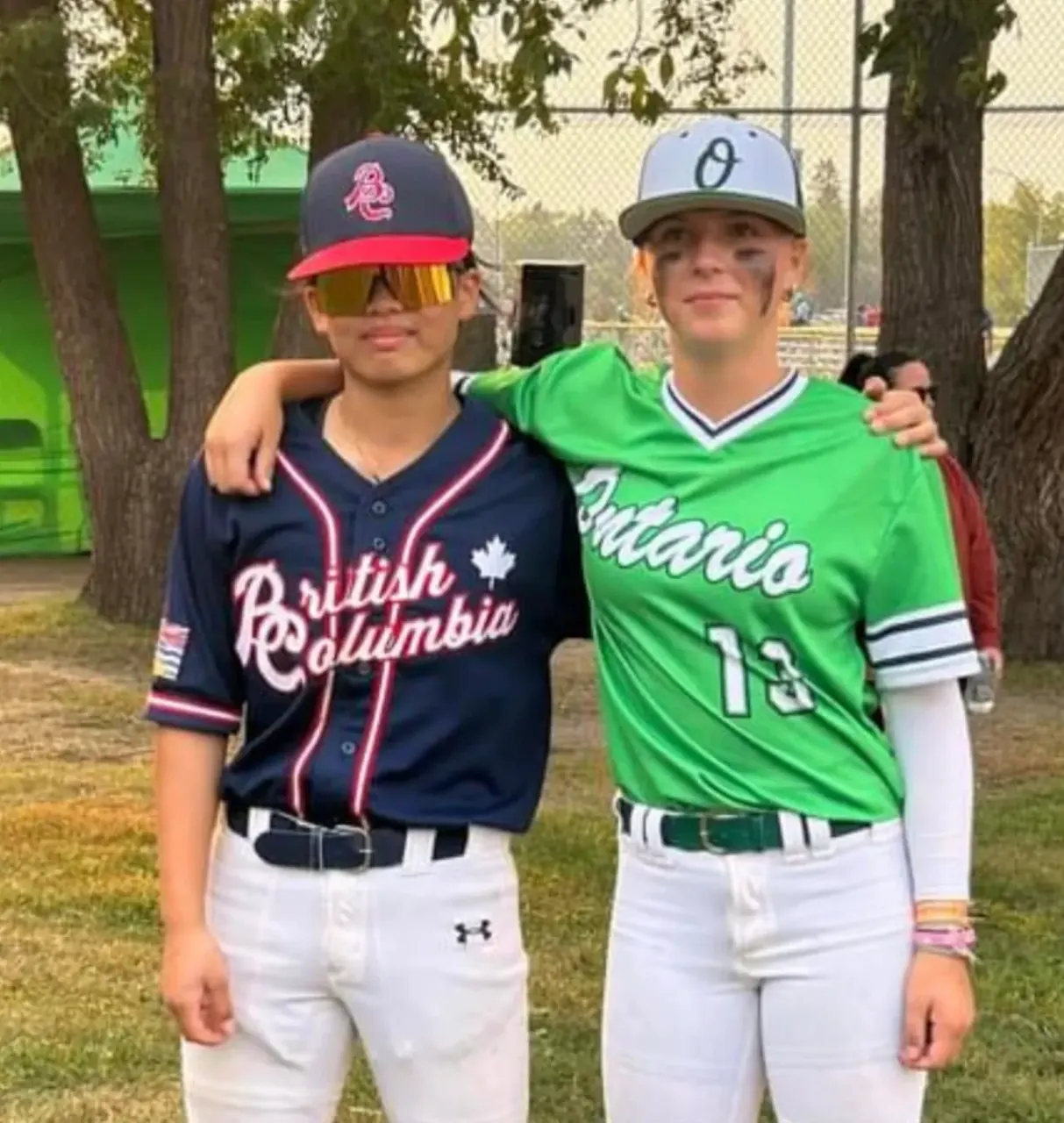 Finleigh Kane in a Team Ontario jersey standing with a British Columbia player