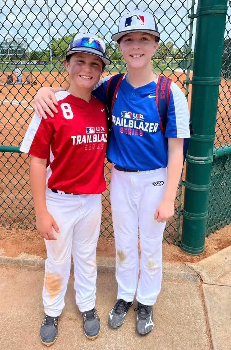 Finleigh Kane in an MLB Trailblazer Series jersey standing with a teammate on the field