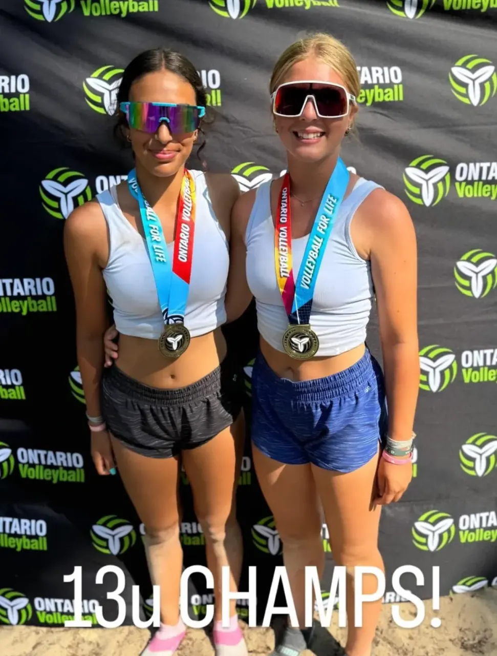 Finleigh Kane and her partner wearing Ontario Volleyball medals after winning 13U